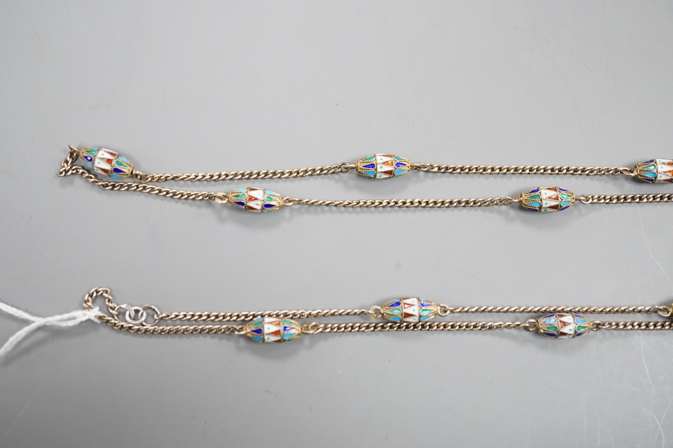 An early 20th century Russian 84 zolotnik and polychrome cloisonné enamel necklace, set with thirteen torpedo shaped enamelled links, 94cm.